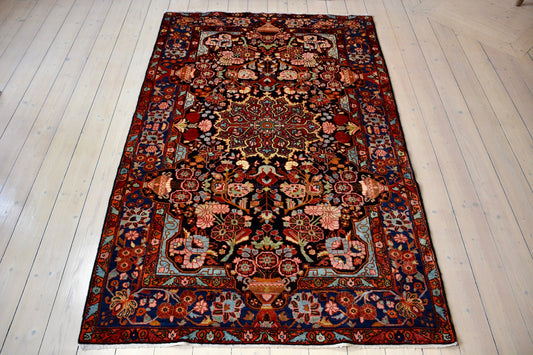 Semiantique Persian handknotted village rug from the Nahavand district. Size 128 x 224 cm.