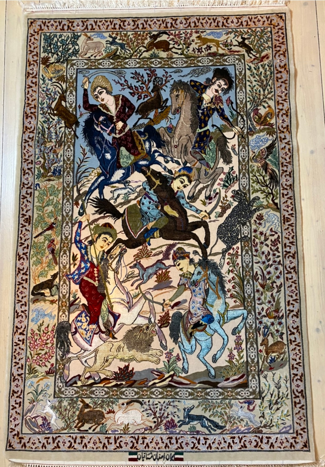 A high quality Persian hand-knotted atelier Isfahan carpet with 40% pure silk inlays with a hunting motiv. Size 130x170. Signed!