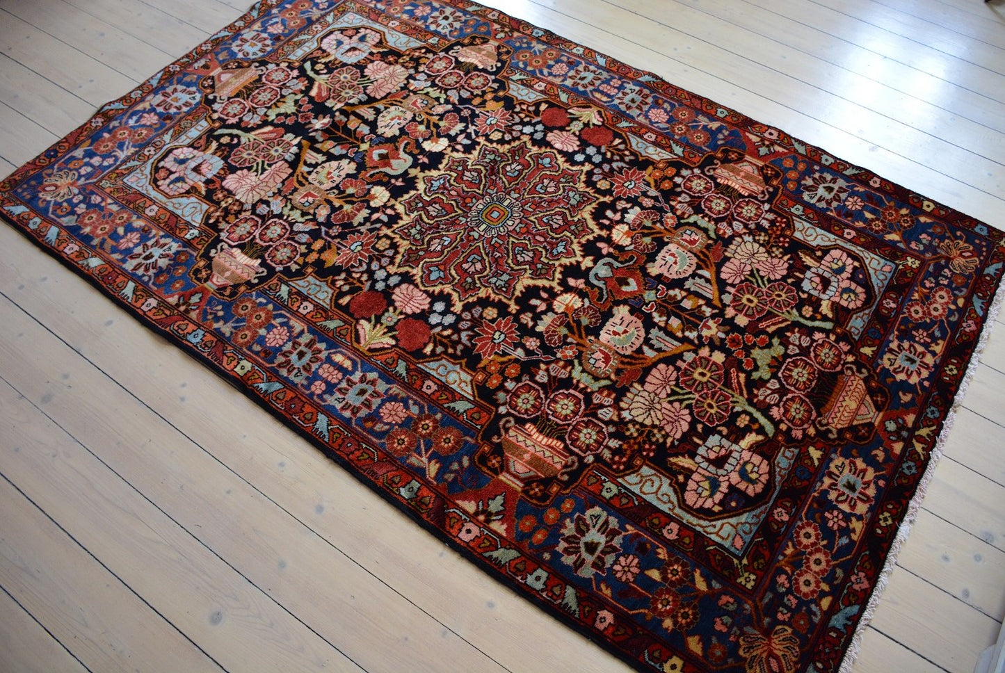 Semiantique Persian handknotted village rug from the Nahavand district. Size 128 x 224 cm.