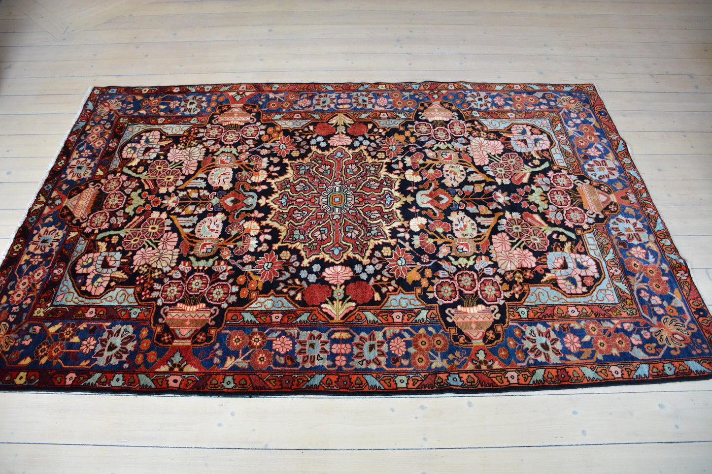 Semiantique Persian handknotted village rug from the Nahavand district. Size 128 x 224 cm.